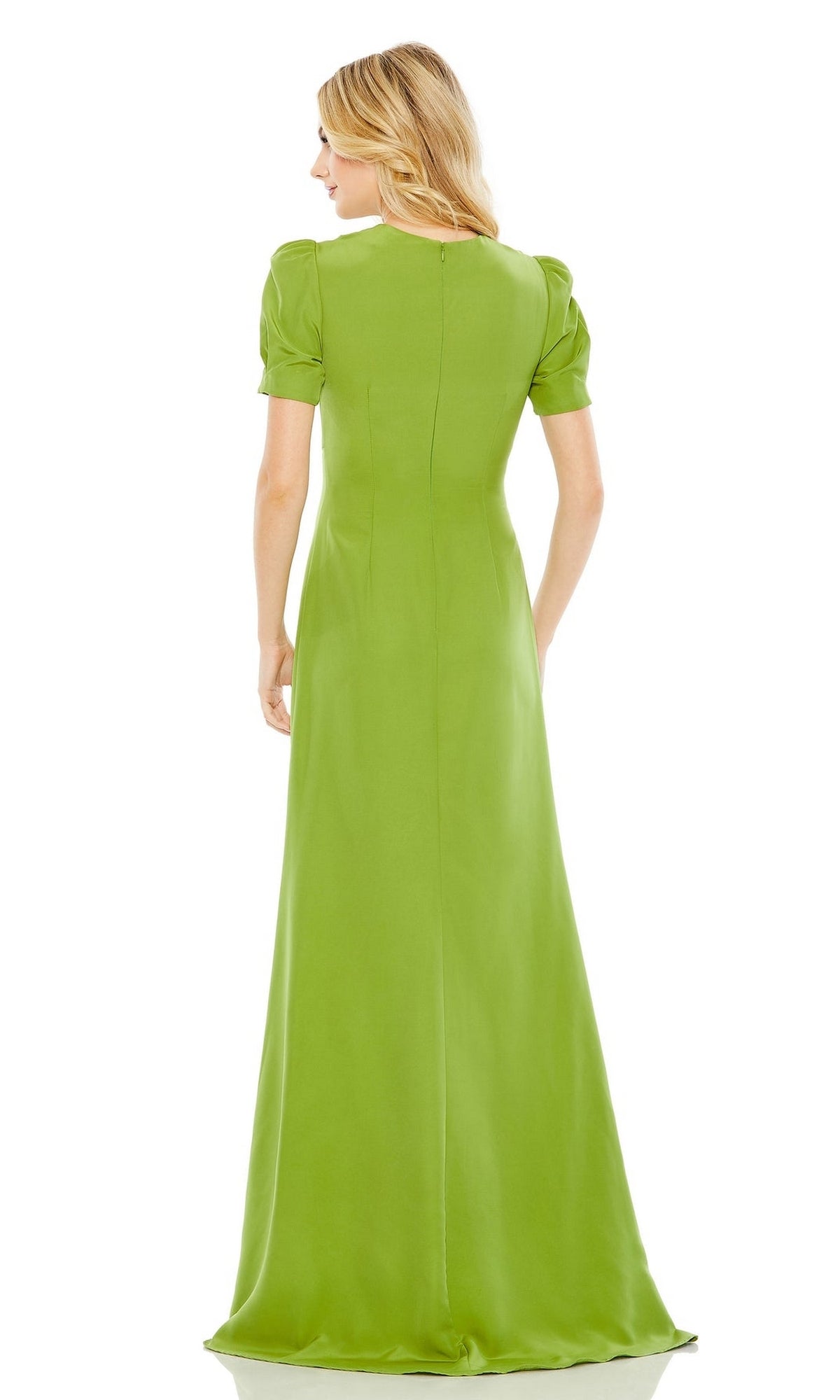 A woman faces away, wearing the Mac Duggal 2630 short-sleeve long formal dress in light green, featuring a fitted bodice and a flowing floor-length skirt.